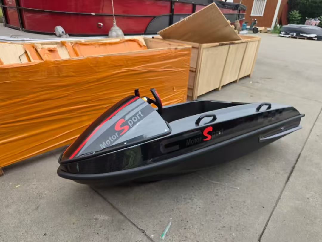 David’s black LakeVolt mini jet boat beside its shipping crate on the day it was delivered